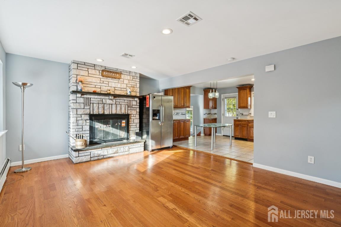 25 Reed Street Edison, NJ 08817 - Photo 2 of 23 a view of a livingroom with wooden floor and a fireplace