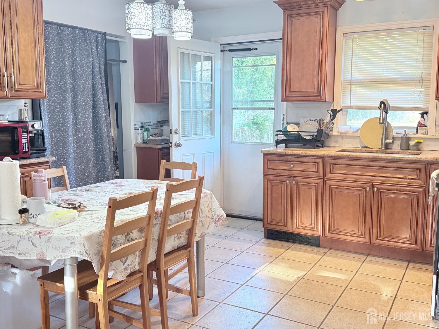 25 Reed Street Edison, NJ 08817 - Photo 2 of 3 a kitchen with stainless steel appliances a sink cabinets and window