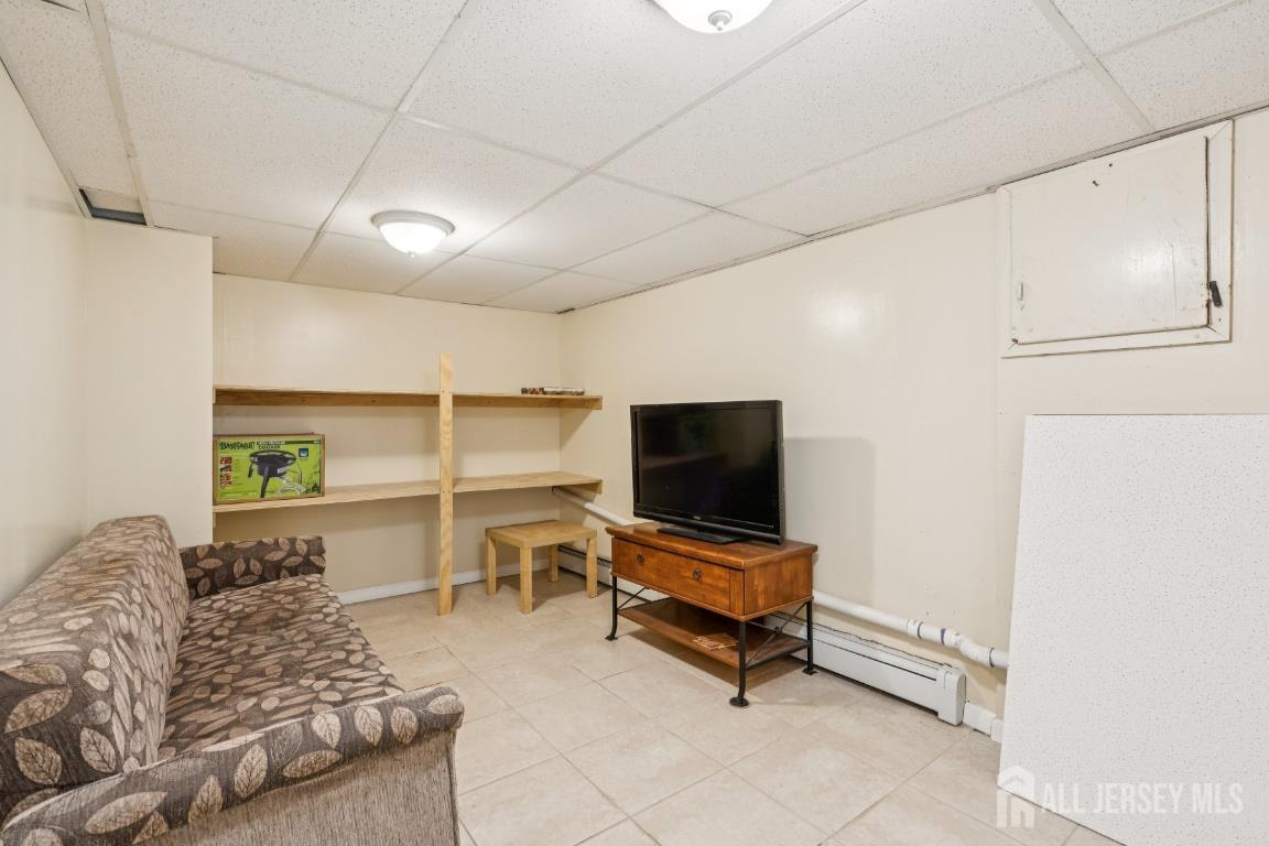 25 Reed Street Edison, NJ 08817 - Photo 21 of 23 a living room with furniture and a flat screen tv