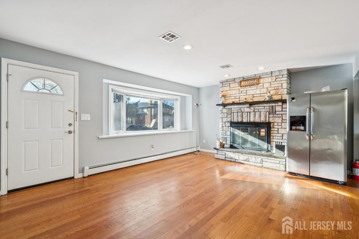 25 Reed Street Edison, NJ 08817 - Photo 3 of 23 a view of an empty room with a window and wooden floor