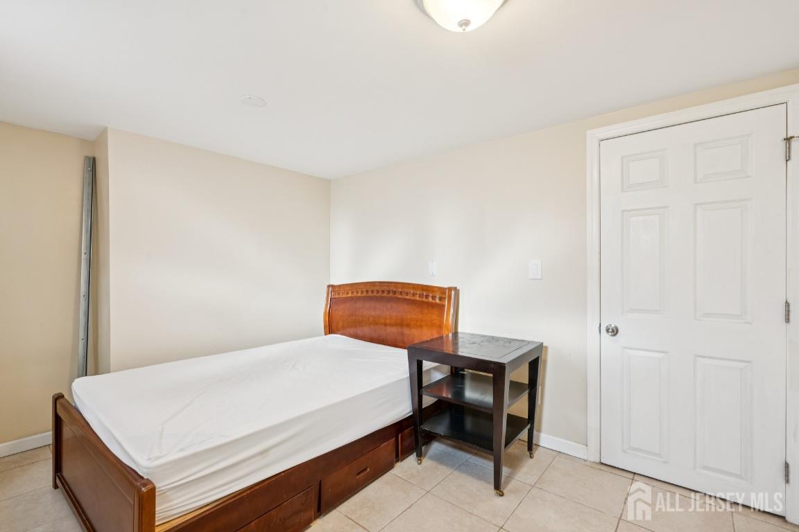 25 Reed Street Edison, NJ 08817 - Photo 9 of 23 a bedroom with a bed and a table in it