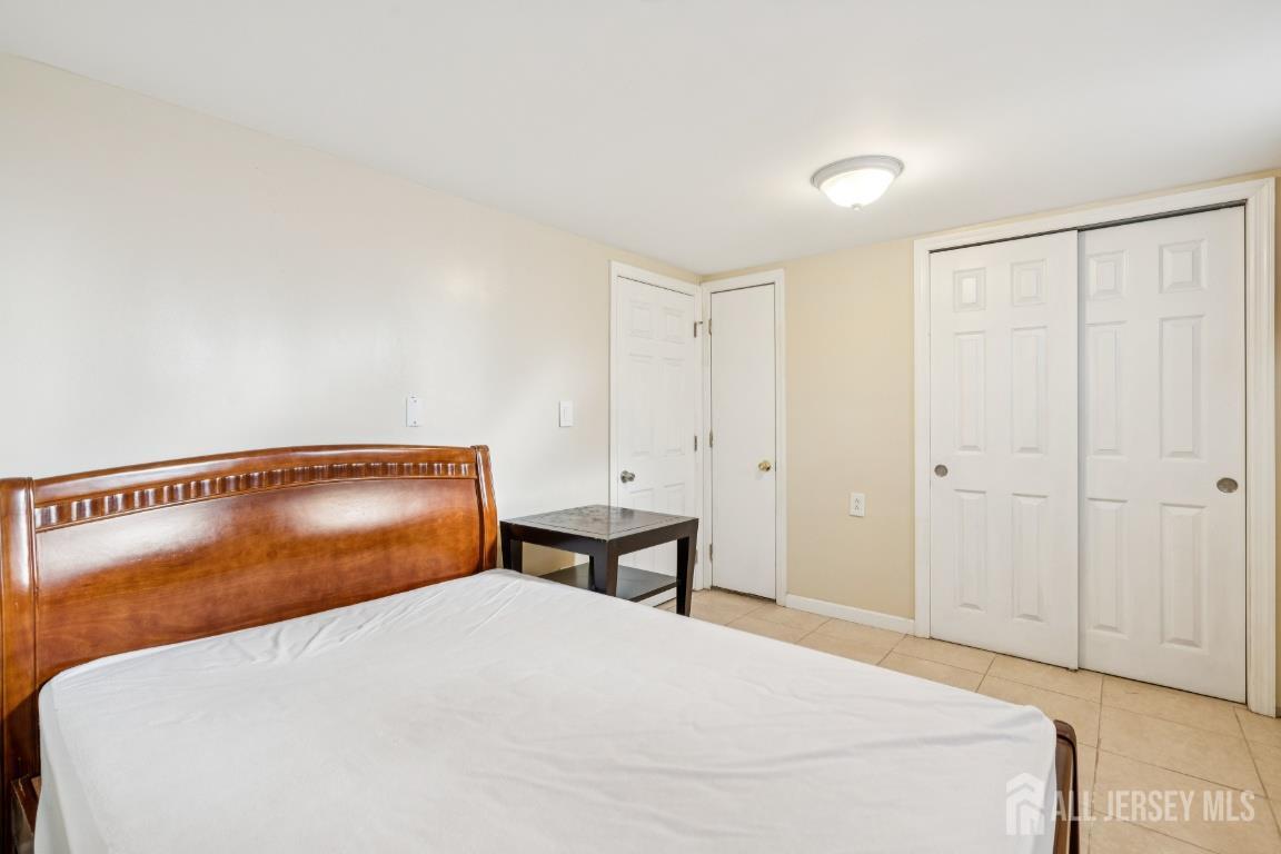 25 Reed Street Edison, NJ 08817 - Photo 10 of 23 a bedroom with a bed and cabinet