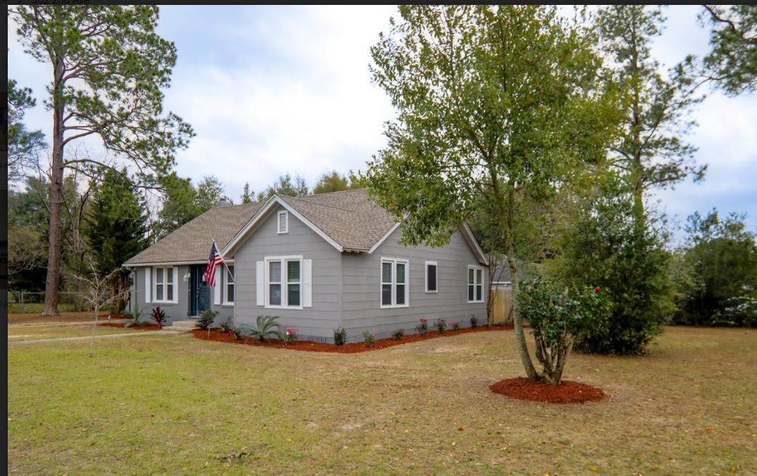 302 East 2nd Avenue Crestview, FL 32536 - Photo 11 of 12 a front view of a house with a garden