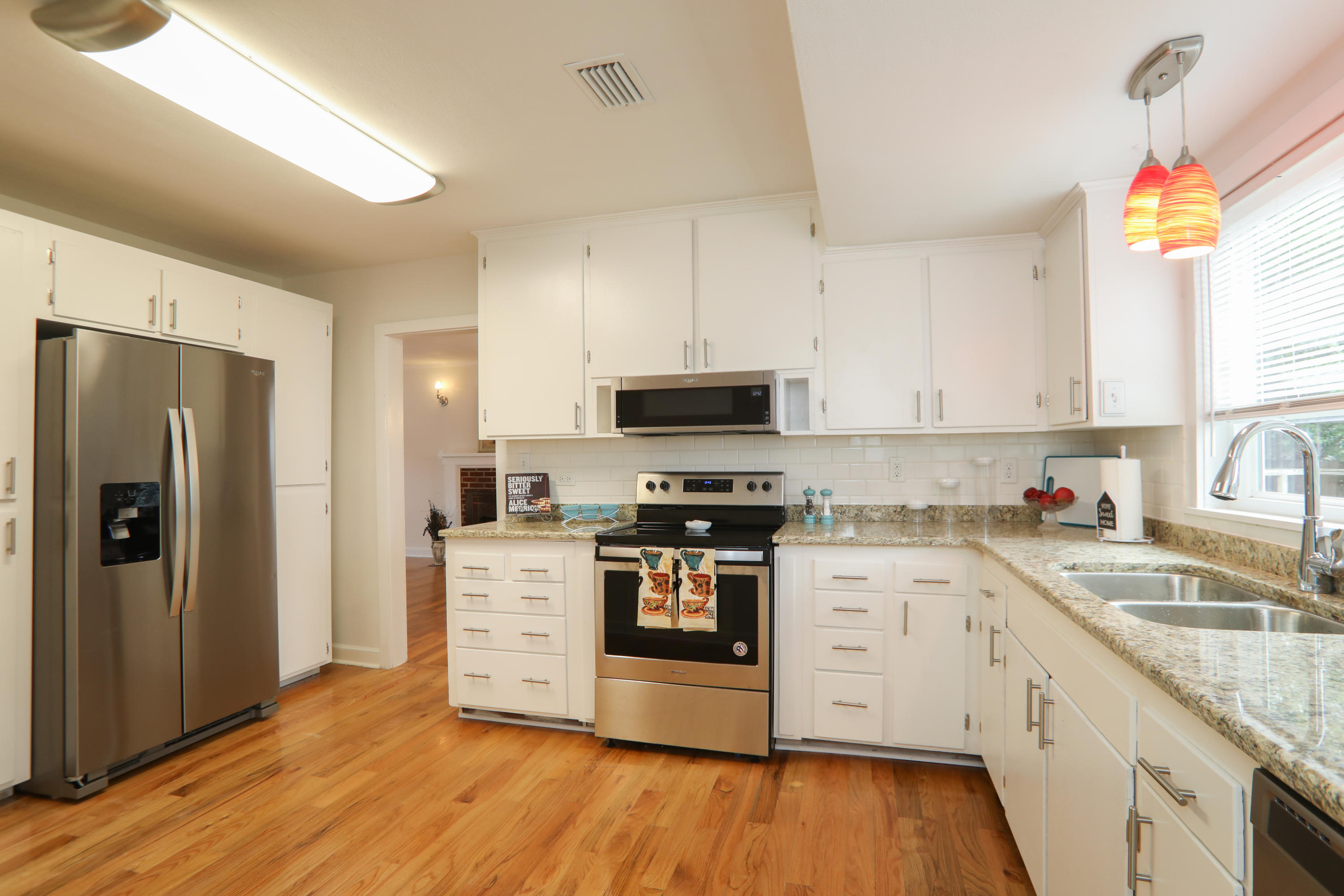 302 East 2nd Avenue Crestview, FL 32536 - Photo 2 of 12 a kitchen with a sink wooden floor and stainless steel appliances