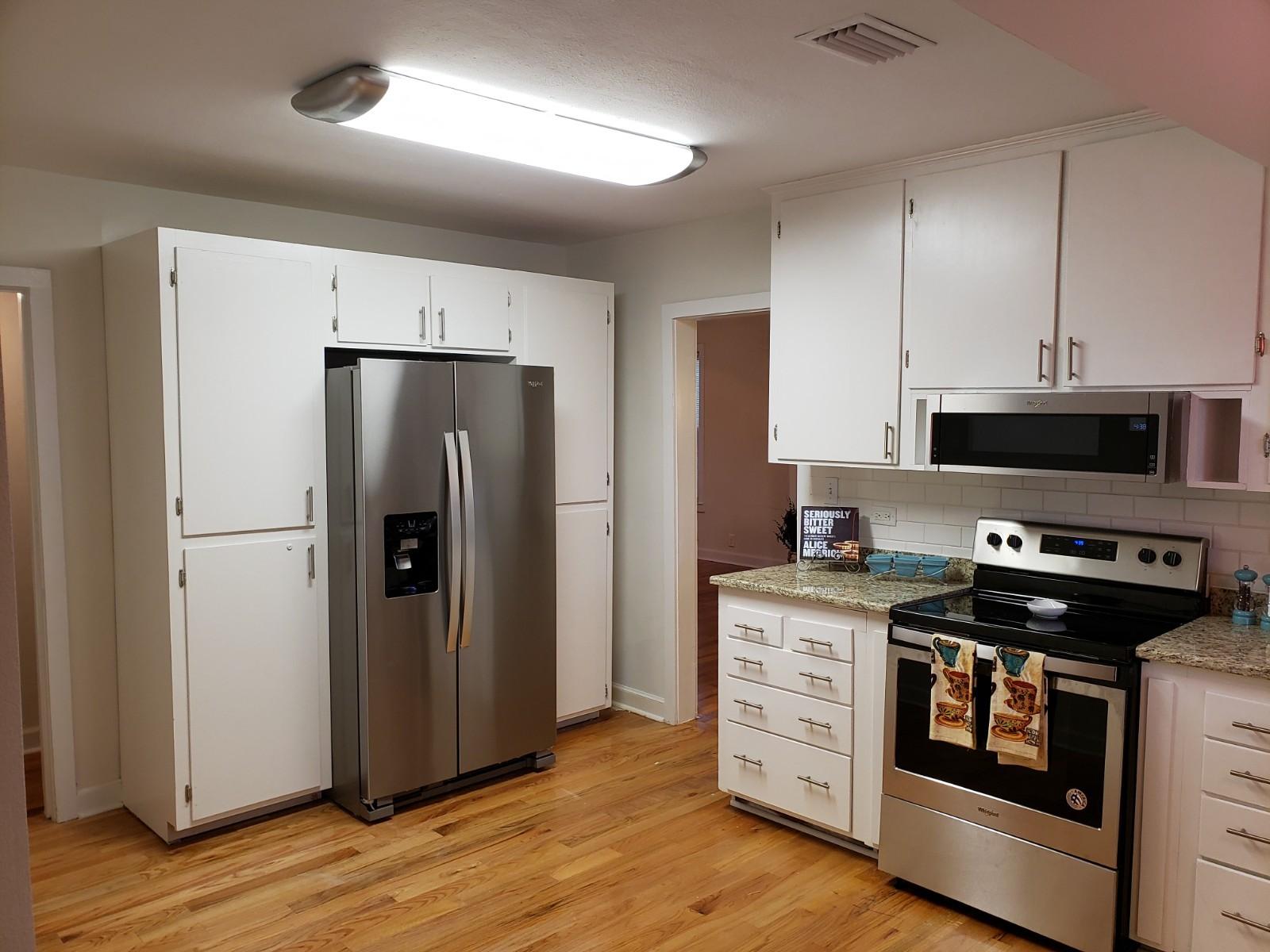 302 East 2nd Avenue Crestview, FL 32536 - Photo 3 of 12 a kitchen with stainless steel appliances a stove a sink and a refrigerator