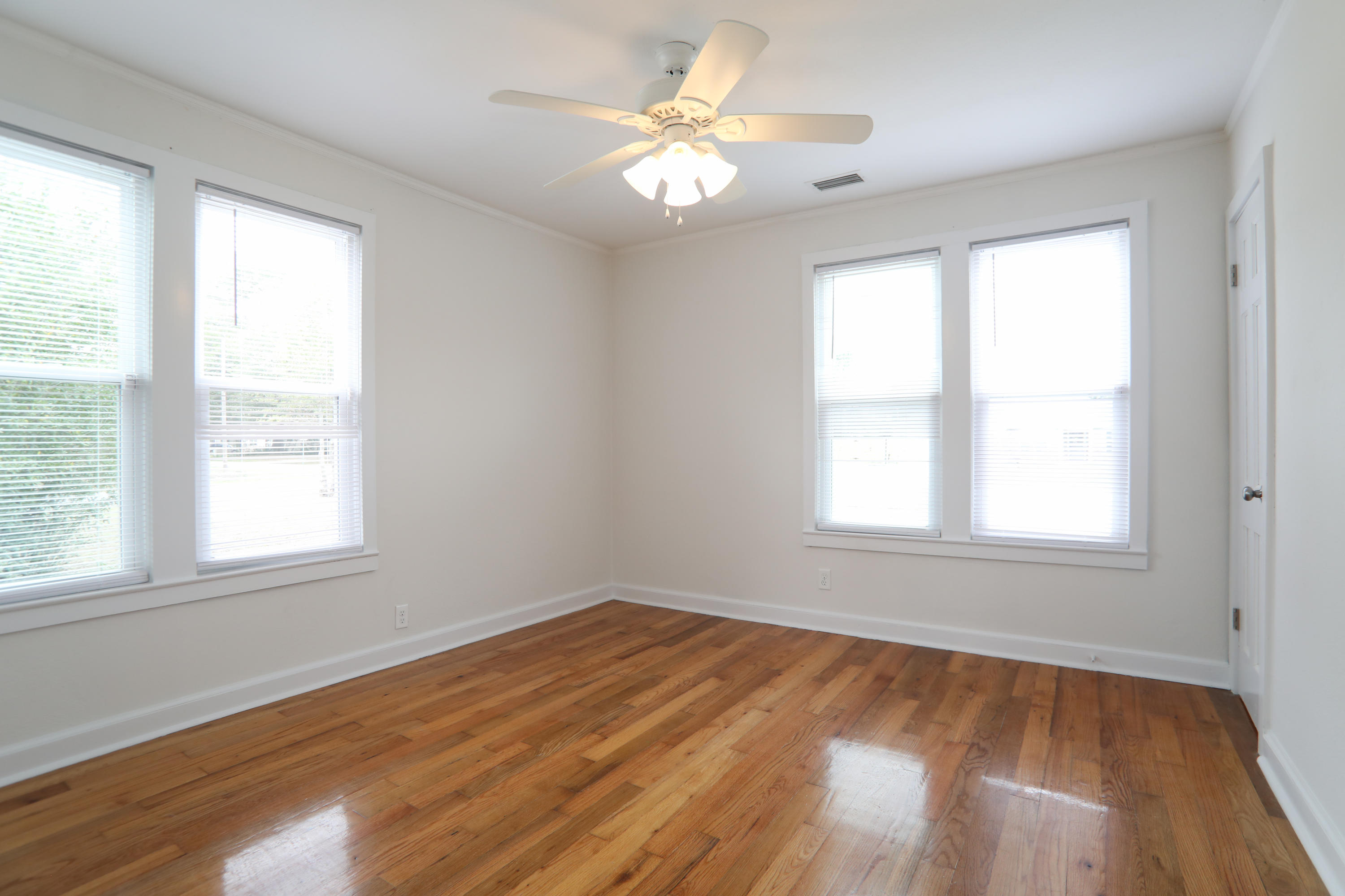 302 East 2nd Avenue Crestview, FL 32536 - Photo 7 of 12 an empty room with a window and a fan