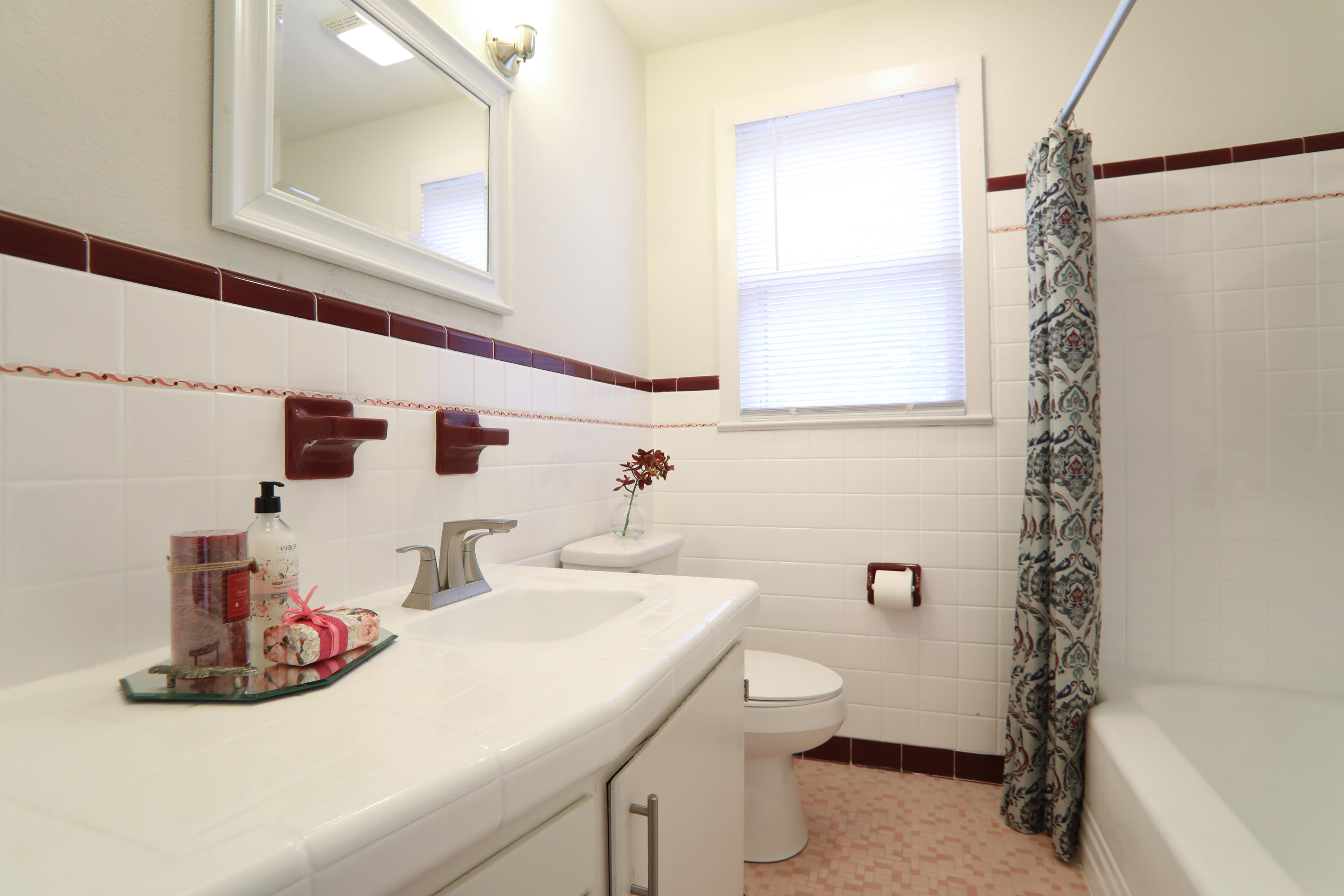 302 East 2nd Avenue Crestview, FL 32536 - Photo 8 of 12 a bathroom with a sink a toilet and shower curtain
