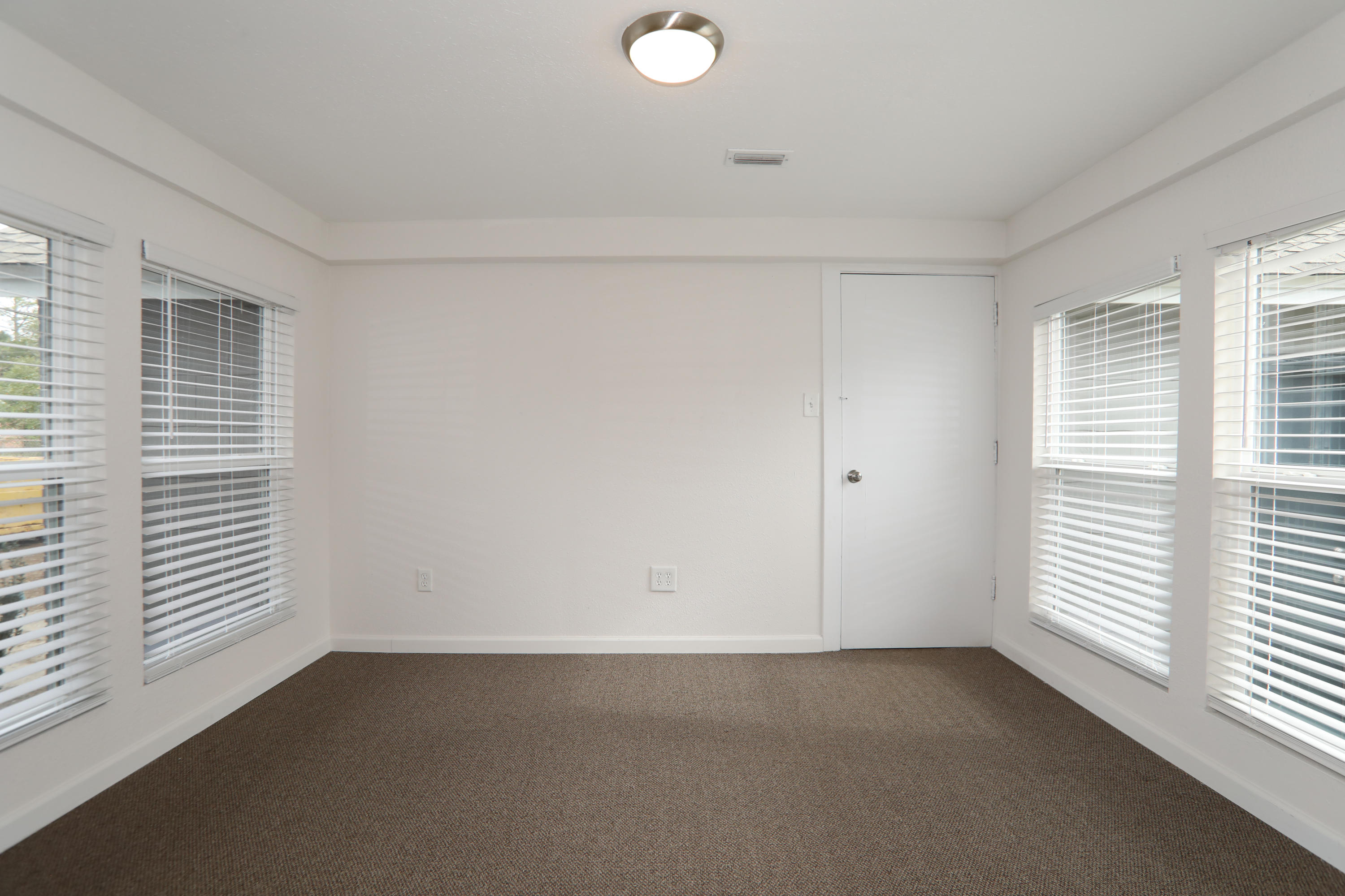302 East 2nd Avenue Crestview, FL 32536 - Photo 10 of 12 an empty room with windows