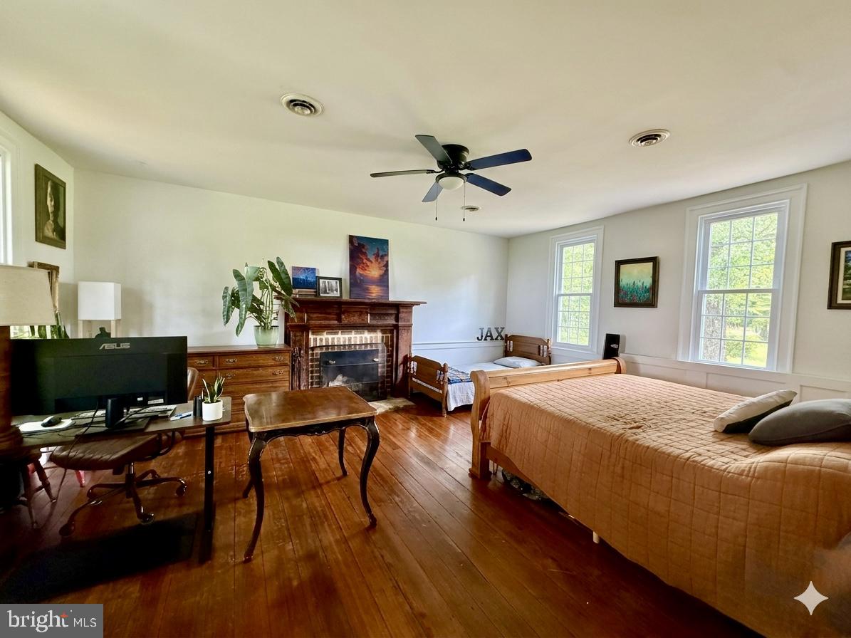 2349 Skinkers Neck Road Rappahannock Academy, VA 22538 - Photo 50 of 71 a bedroom with a bed and a flat screen tv with wooden floor