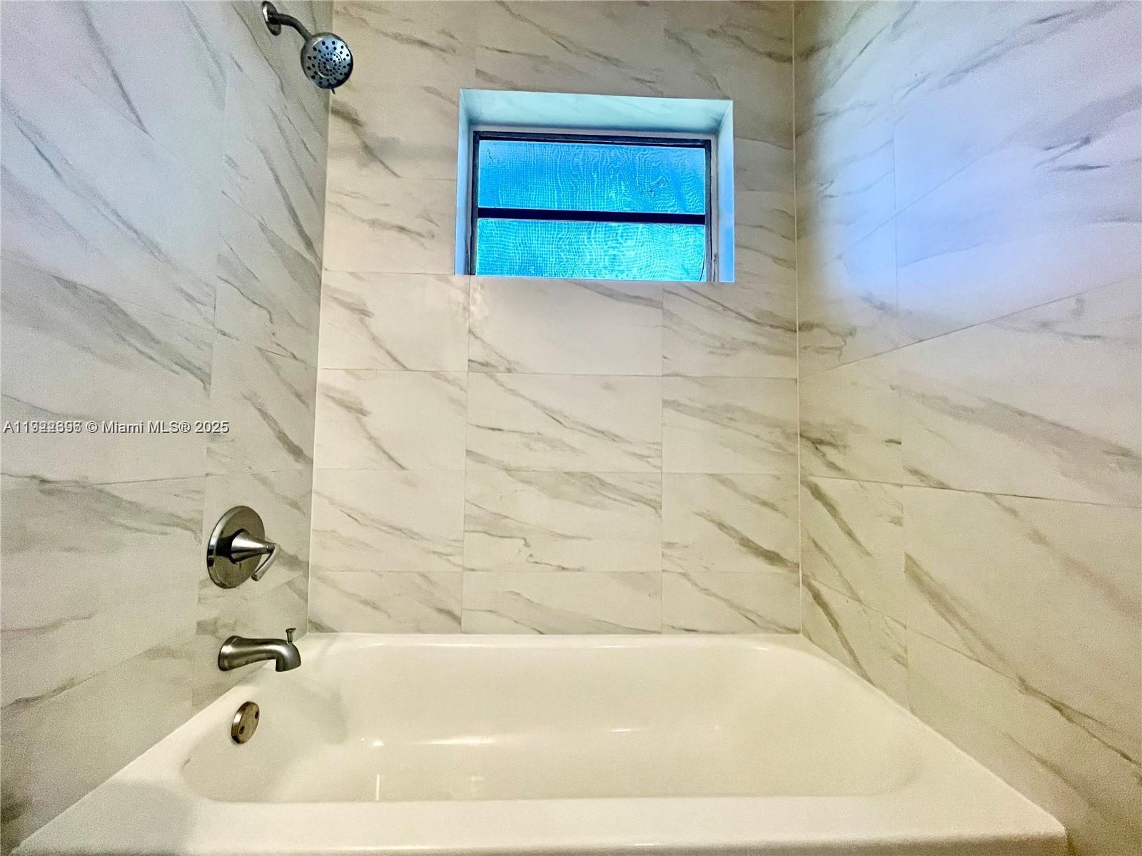 213 Southwest 10th Street Hallandale Beach, FL 33009 - Photo 6 of 8 a bathroom with a bathtub