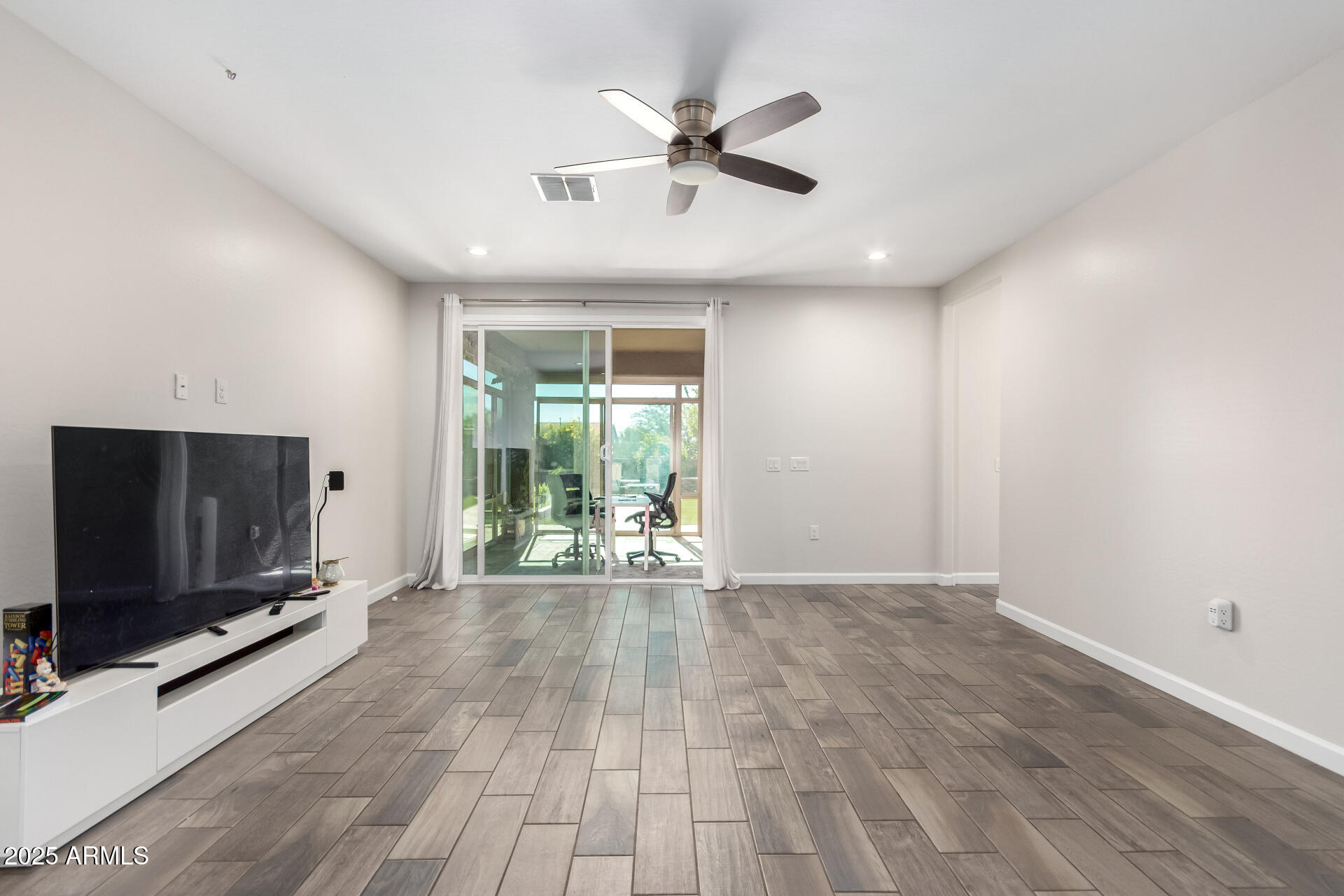 1927 West Plum Road Phoenix, AZ 85085 - Photo 3 of 17 an empty room with wooden floor and windows