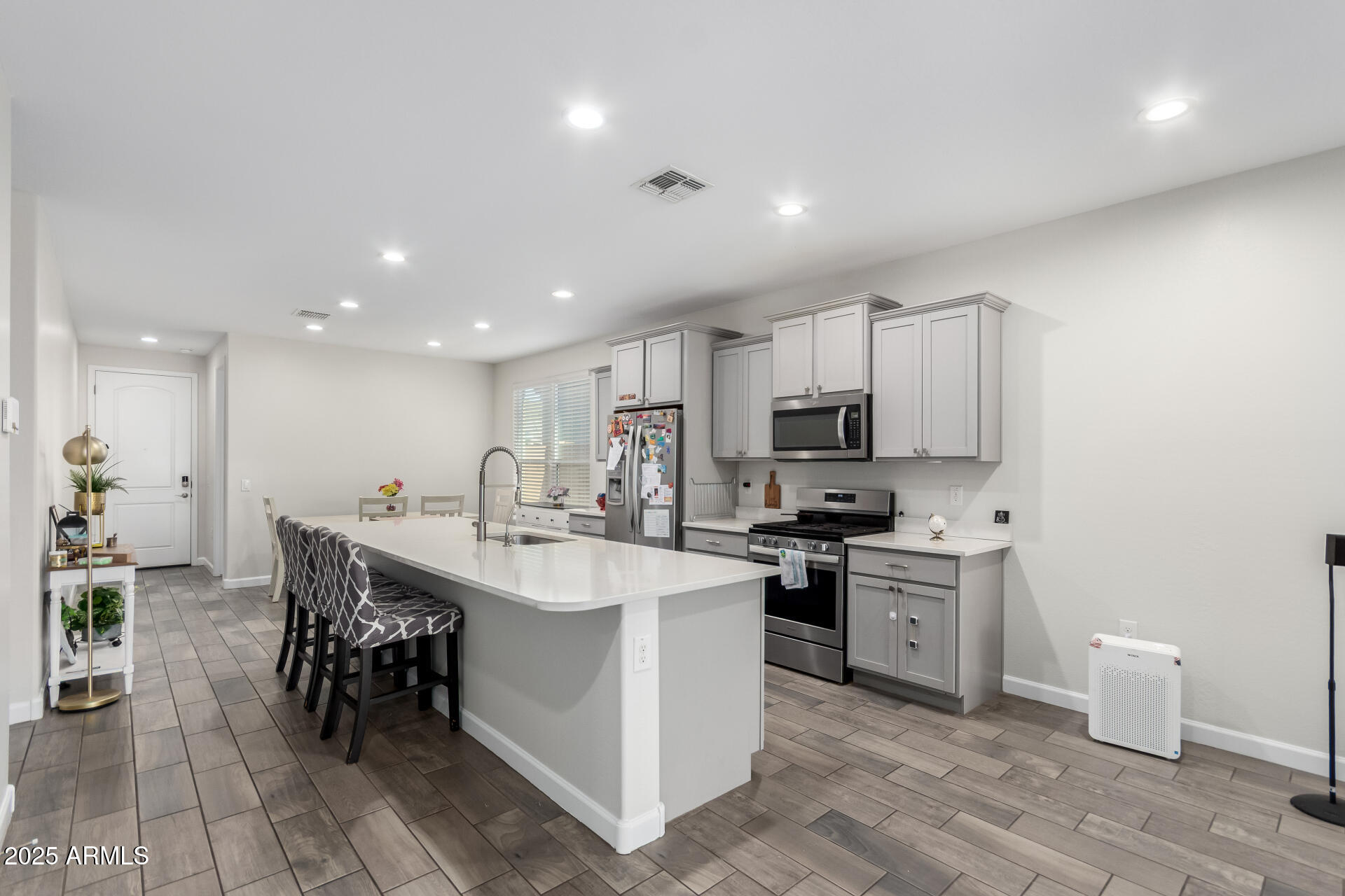 1927 West Plum Road Phoenix, AZ 85085 - Photo 4 of 17 a large white kitchen with stainless steel appliances lots of counter space and breakfast area