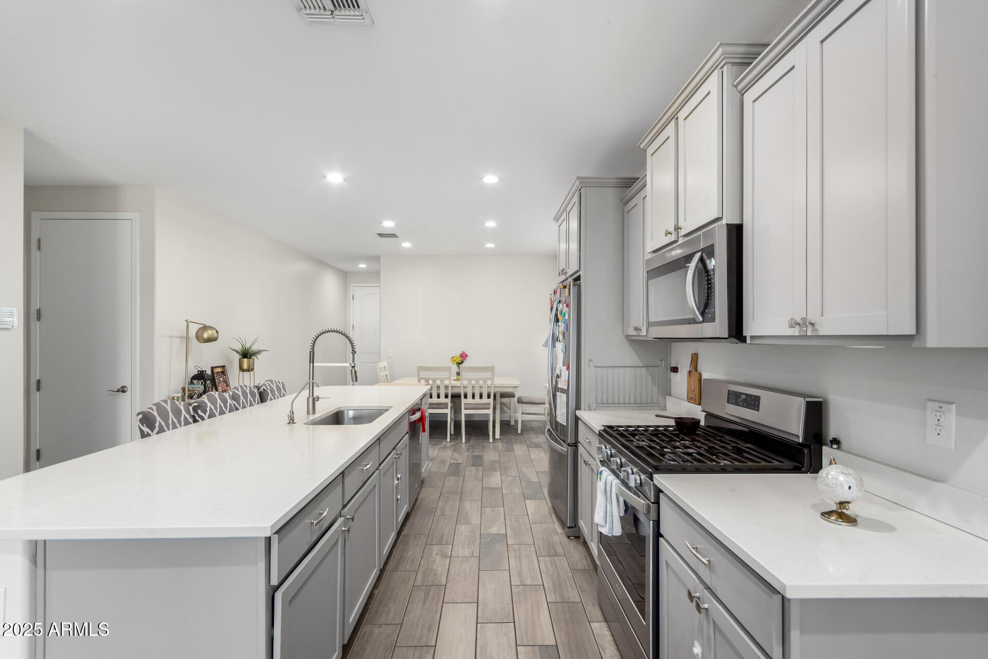 1927 West Plum Road Phoenix, AZ 85085 - Photo 5 of 17 a kitchen with a sink stove and cabinets