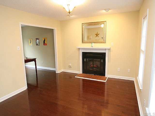 2813 Duke Homestead Road Durham, NC 27705 - Photo 2 of 6 Brazillian cherry hardwood floors and a beautiful woodburning fireplace make this a perfect spot to relax and unwind.