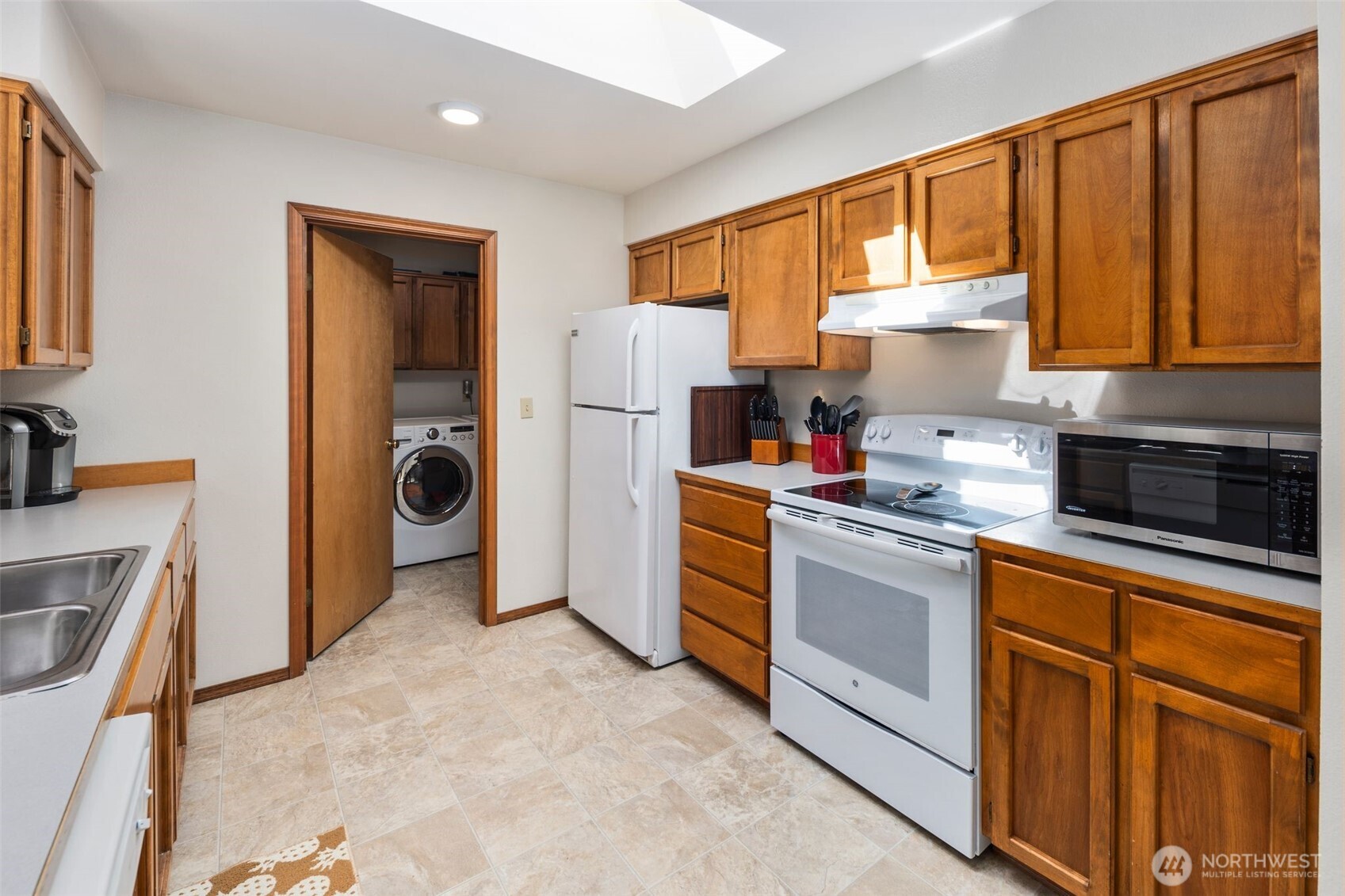 22424 South Prairie Road East Bonney Lake, WA 98391 - Photo 11 of 32 a kitchen with a refrigerator and a stove top oven