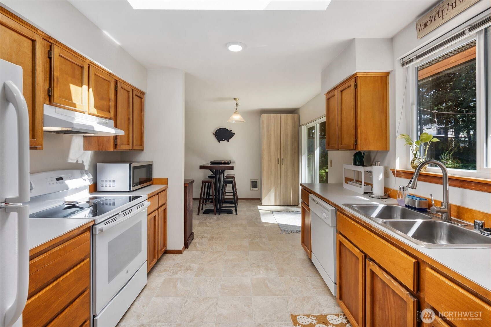 22424 South Prairie Road East Bonney Lake, WA 98391 - Photo 13 of 32 a kitchen with stainless steel appliances a sink stove and cabinets