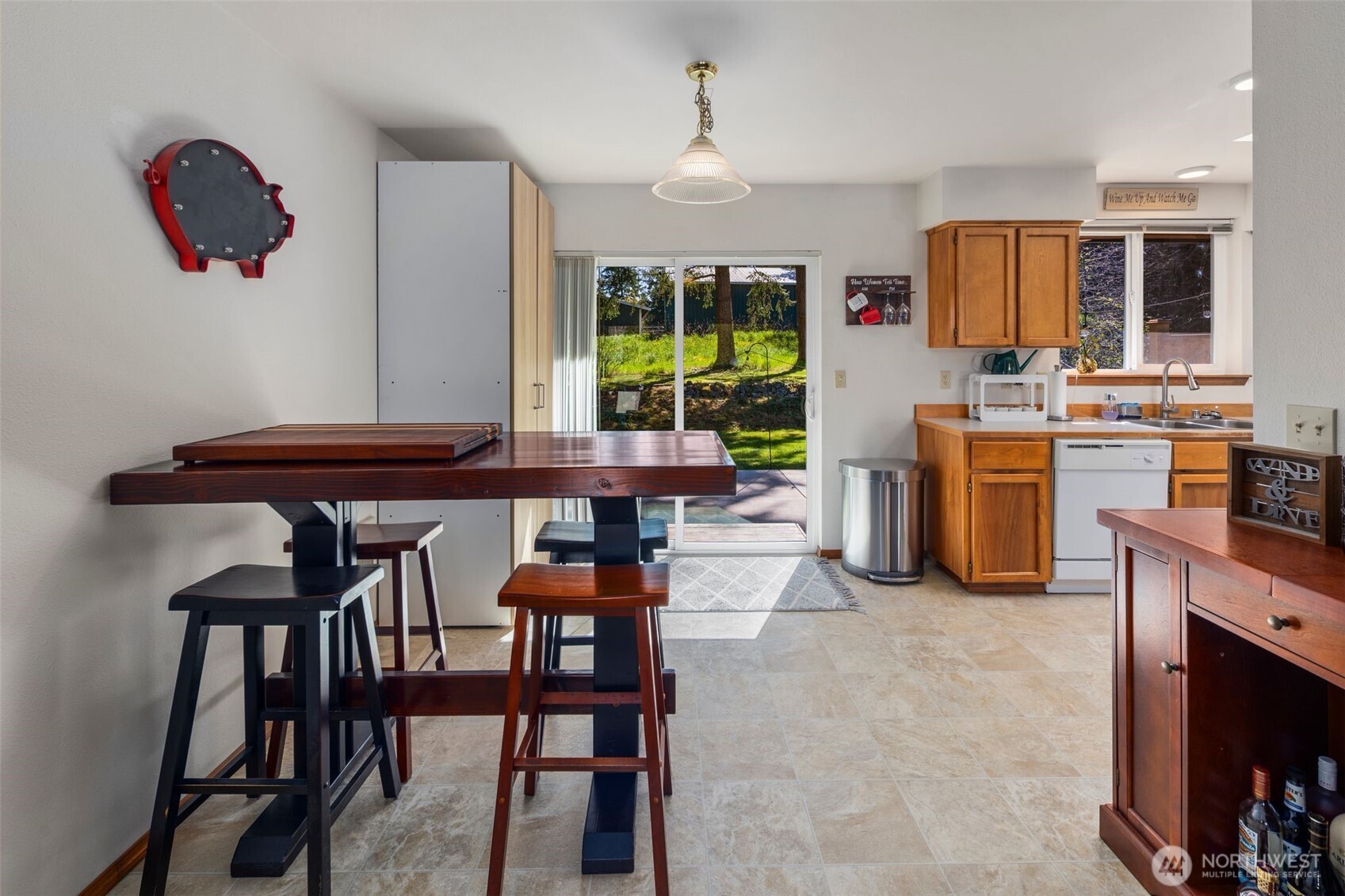 22424 South Prairie Road East Bonney Lake, WA 98391 - Photo 15 of 32 a kitchen with stainless steel appliances kitchen island granite countertop a table and chairs in it