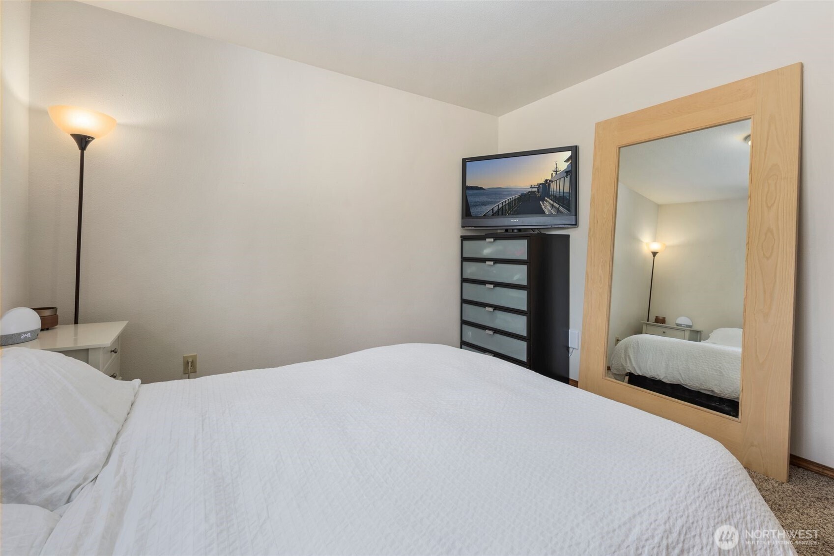 22424 South Prairie Road East Bonney Lake, WA 98391 - Photo 17 of 32 a bedroom with a bed and a mirror