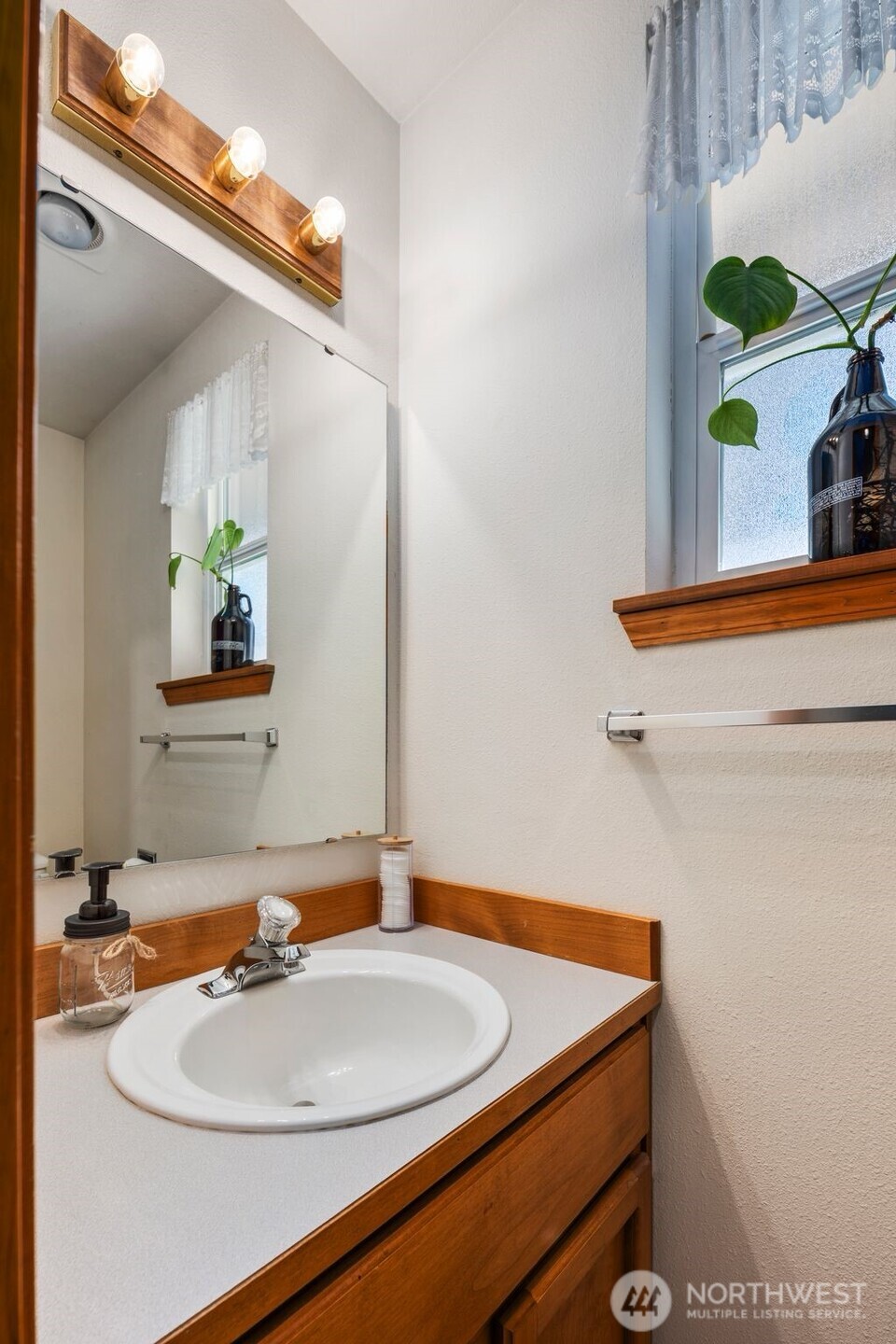 22424 South Prairie Road East Bonney Lake, WA 98391 - Photo 22 of 32 a bathroom with a sink and a mirror