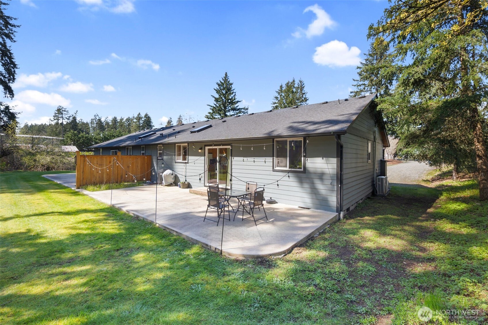 22424 South Prairie Road East Bonney Lake, WA 98391 - Photo 24 of 32 a view of a patio with table and chairs potted plants and large tree