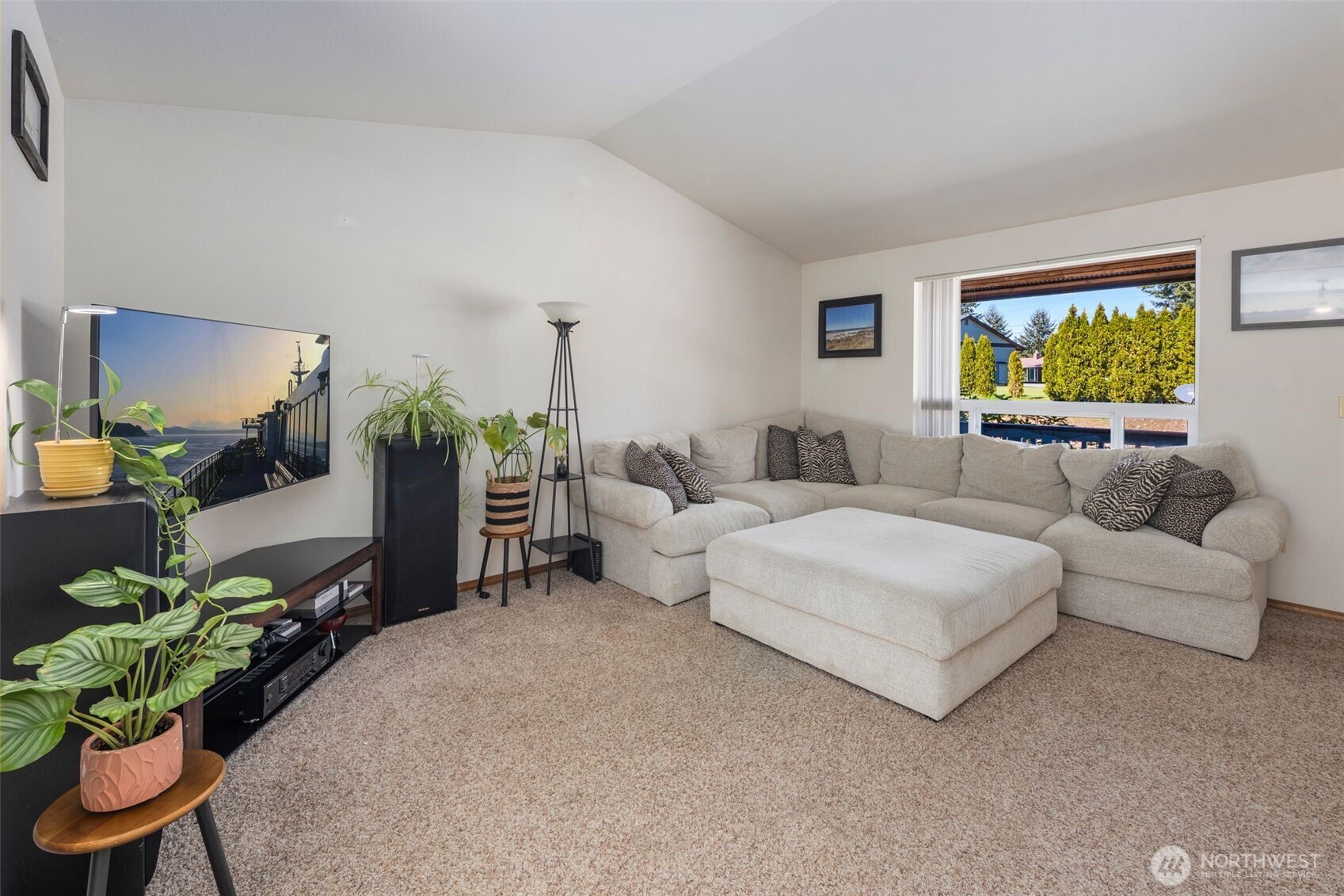 22424 South Prairie Road East Bonney Lake, WA 98391 - Photo 7 of 32 a living room with furniture a chandelier and a flat screen tv