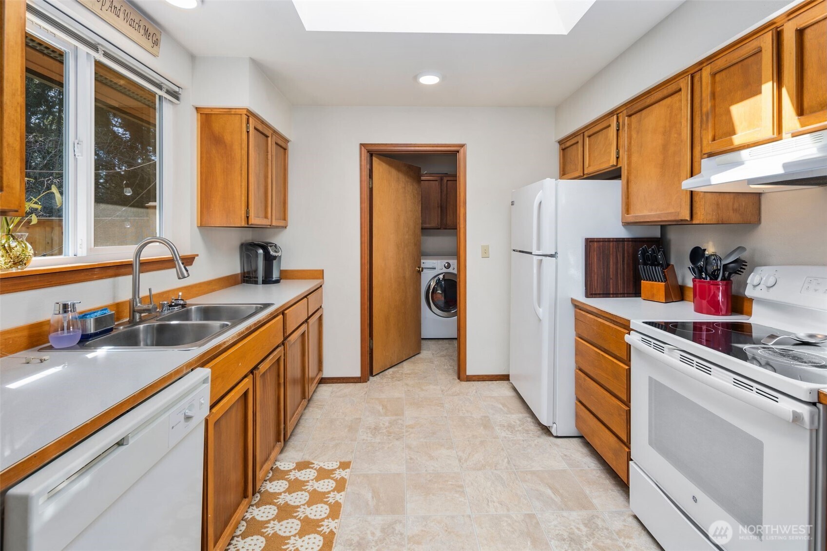 22424 South Prairie Road East Bonney Lake, WA 98391 - Photo 9 of 32 a kitchen with stainless steel appliances granite countertop a sink and a refrigerator