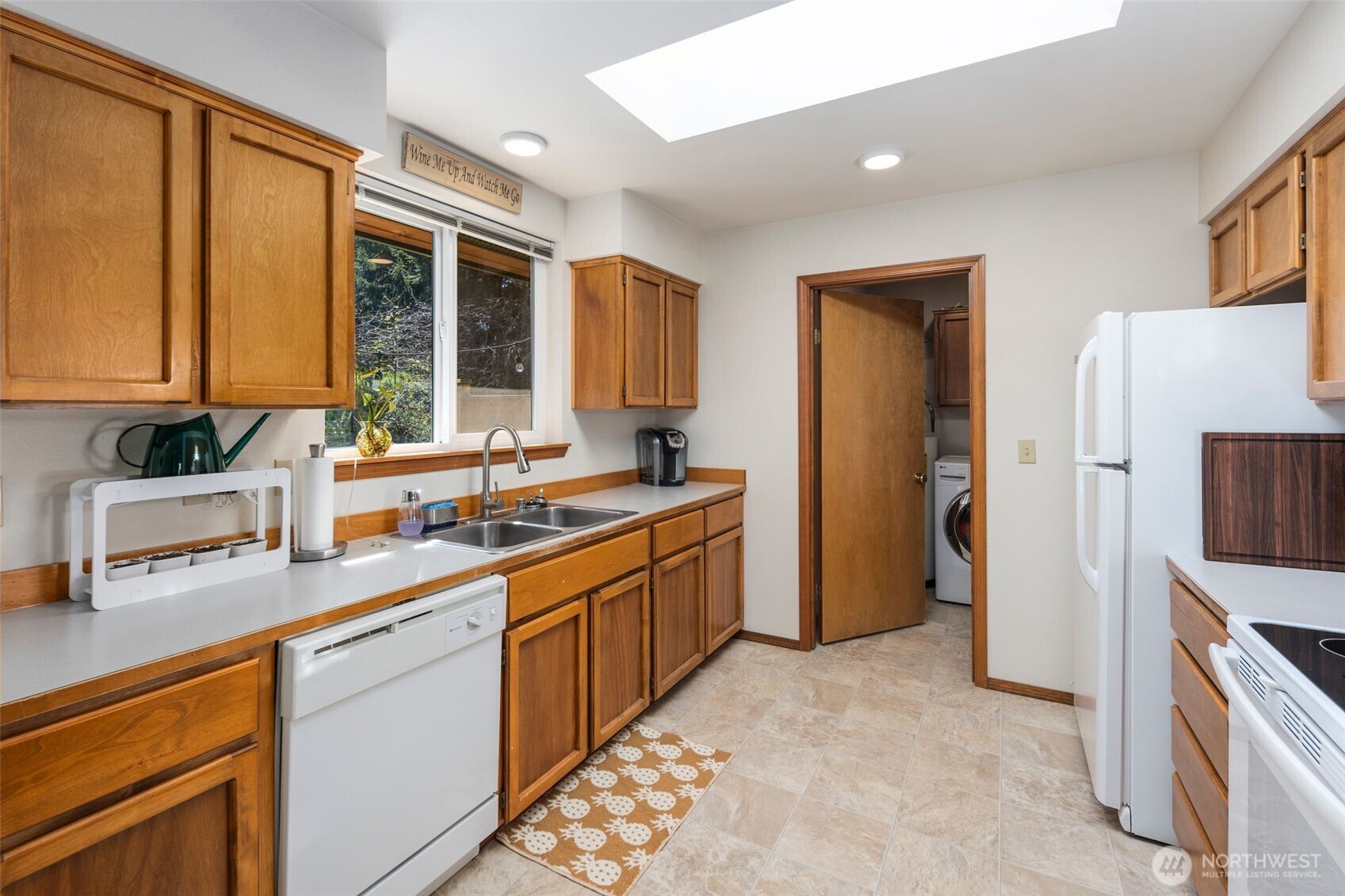 22424 South Prairie Road East Bonney Lake, WA 98391 - Photo 10 of 32 a kitchen with a sink stove and refrigerator