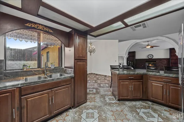 a large kitchen with stainless steel appliances granite countertop a sink and cabinets