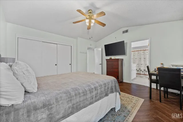 a spacious bedroom with a bed and a table in it