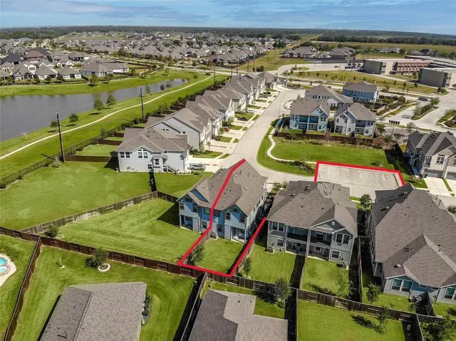 an aerial view of residential houses with outdoor space