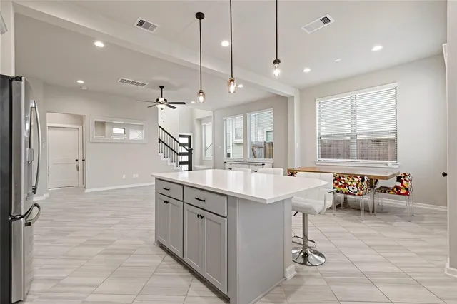 an open kitchen with stainless steel appliances granite countertop a sink and counter space
