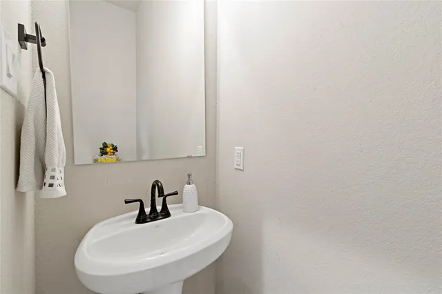 a bathroom with a sink and mirror