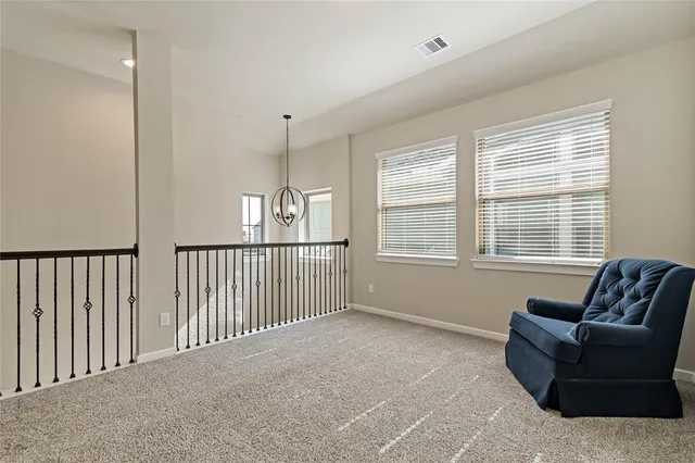 a living room with furniture and windows