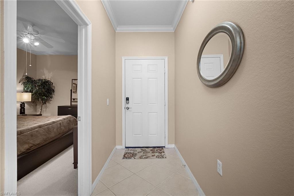 10285 Heritage Bay Boulevard, Unit 817 Naples, FL 34120 - Photo 11 of 42 a bathroom with a granite countertop sink a mirror and a bathtub