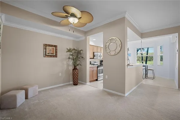 a view of room with furniture and a fan
