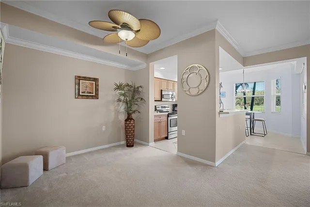 a view of room with furniture and a fan