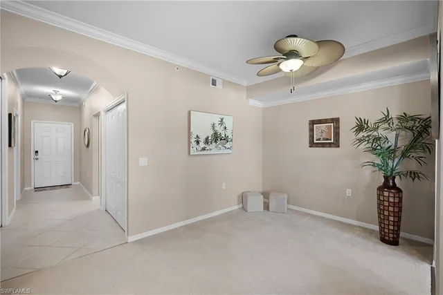 a view of a hallway with a chandelier fan and a potted plant