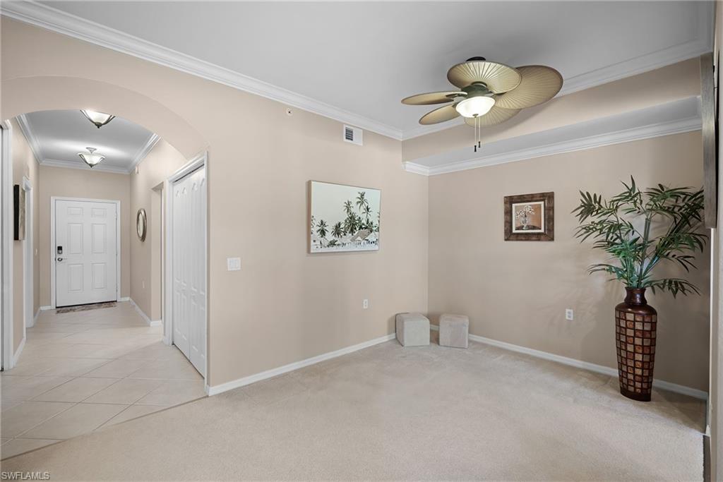 10285 Heritage Bay Boulevard, Unit 817 Naples, FL 34120 - Photo 14 of 42 a view of a hallway with a chandelier fan and a potted plant
