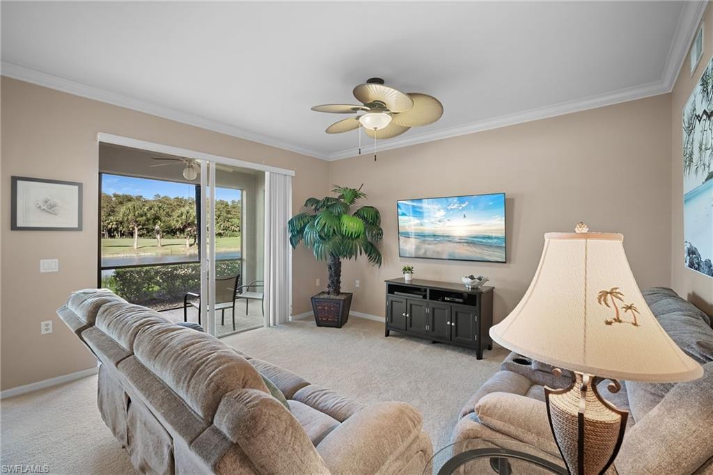 10285 Heritage Bay Boulevard, Unit 817 Naples, FL 34120 - Photo 16 of 42 a living room with furniture and a flat screen tv