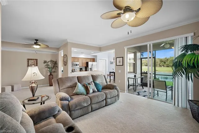 a living room with furniture ceiling fan and a chandelier
