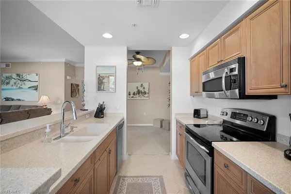 a kitchen with a sink stove top oven and refrigerator
