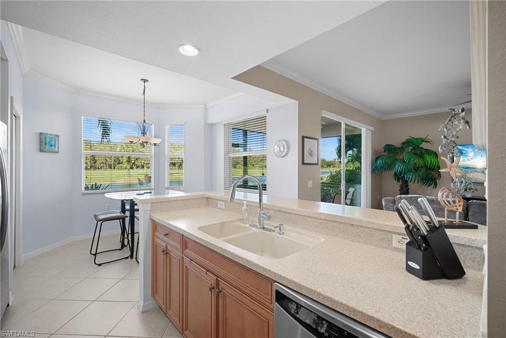 10285 Heritage Bay Boulevard, Unit 817 Naples, FL 34120 - Photo 25 of 42 a kitchen with a sink and a large window