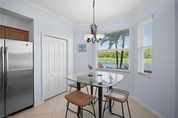 a dining room with furniture a chandelier and window