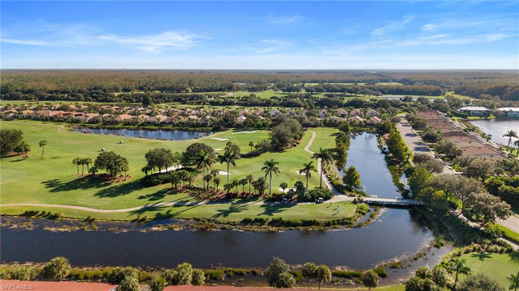 10285 Heritage Bay Boulevard, Unit 817 Naples, FL 34120 - Photo 40 of 42 an aerial view of ocean and residential houses with outdoor space