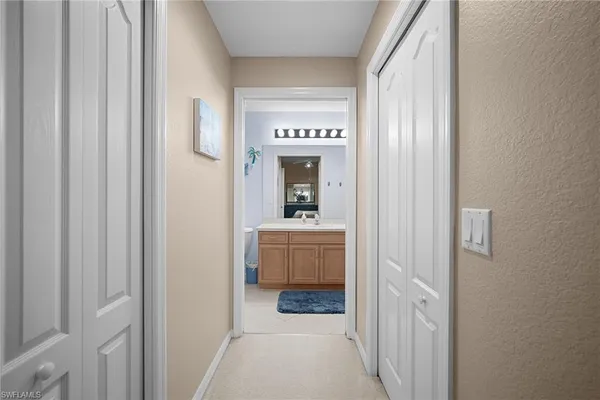 a view of a hallway view with wooden floor and furniture