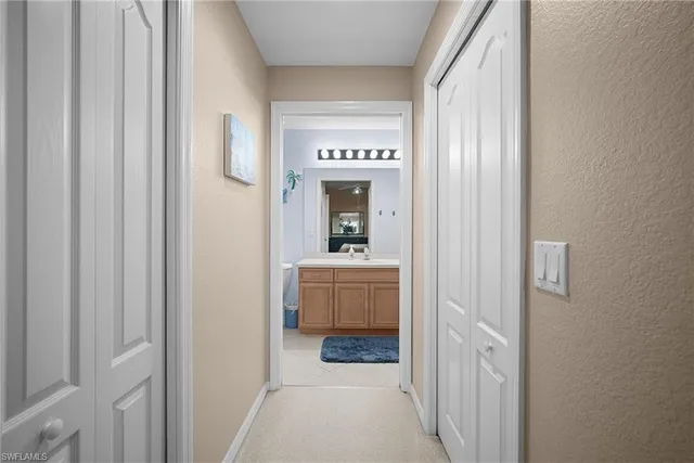 a view of a hallway view with wooden floor and furniture