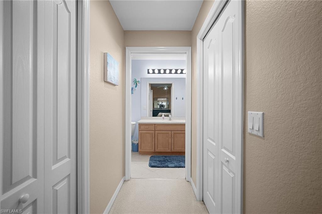 10285 Heritage Bay Boulevard, Unit 817 Naples, FL 34120 - Photo 4 of 42 a view of a hallway view with wooden floor and furniture