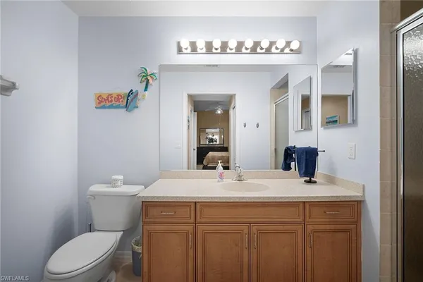 a bathroom with a sink a toilet and a mirror