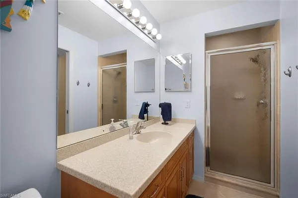 a bathroom with a sink vanity and a mirror