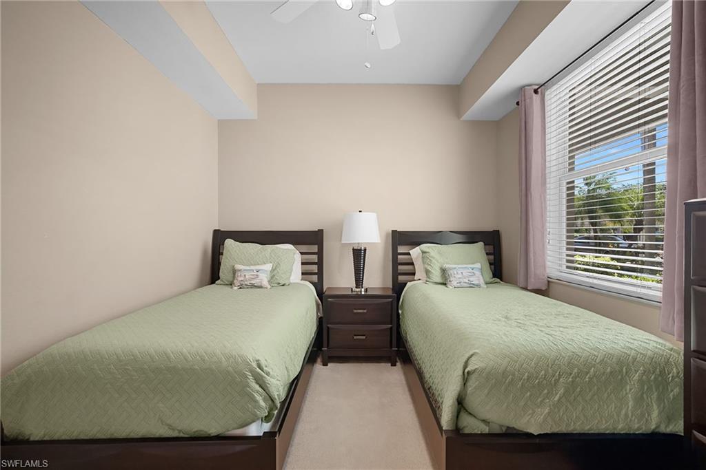 10285 Heritage Bay Boulevard, Unit 817 Naples, FL 34120 - Photo 8 of 42 a bedroom with two beds and windows
